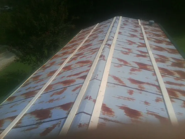 Rusted metal roof panels with new wood purlins before replacement — Storm Damage Roof Repair in Yorkville by Roofing Brothers